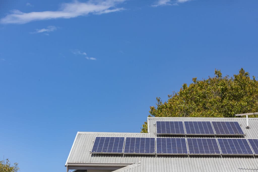 Solar Panels on a House Roof With a Clear Blue Sky