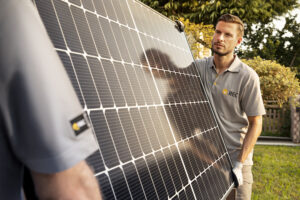 technician installing solar panel outdoors