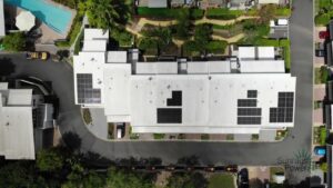 Aerial view of commercial building rooftop with installed solar panels