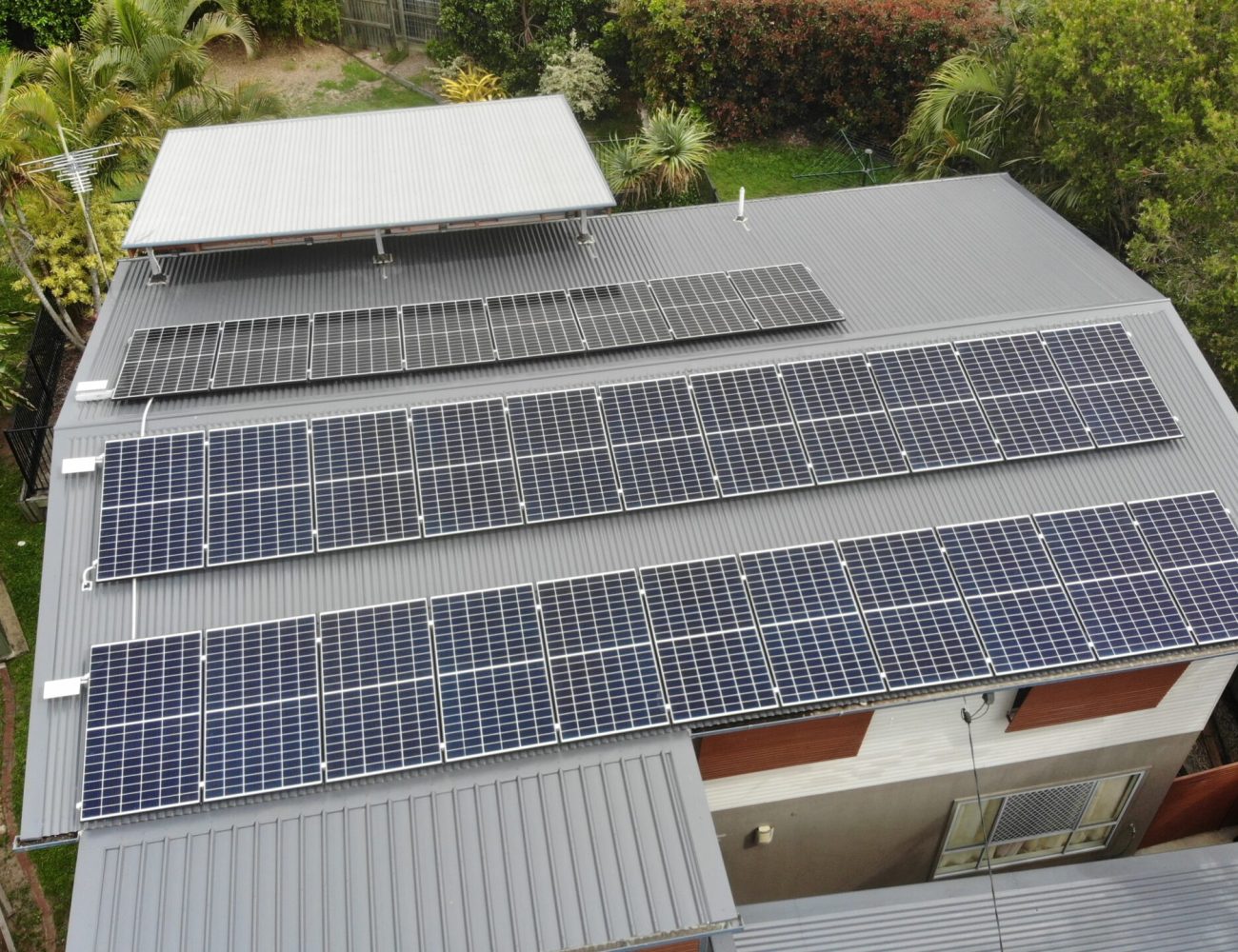 An aerial view of a residential building with solar panels on the roof